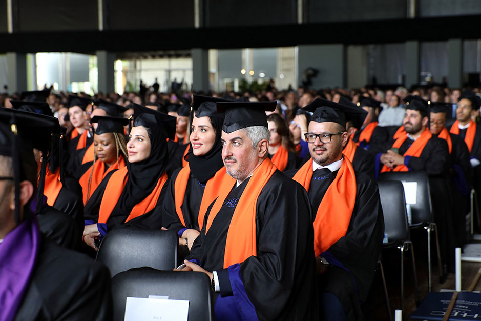 Large group of graduates in academic regalia, during a commencement ceremony