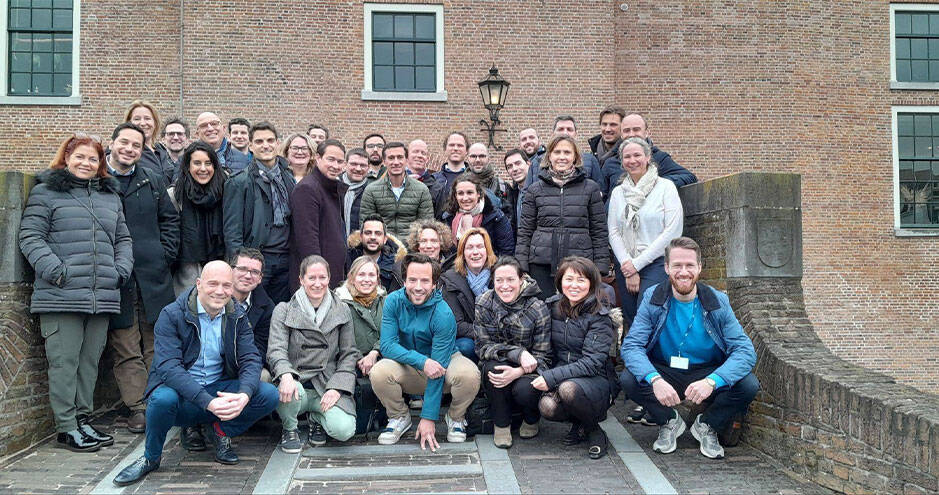 Cohort 3 from the Air France-KLM HEC Paris custom program poses together in front of a brick building